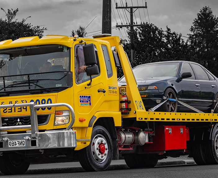 Tow truck with car on the back